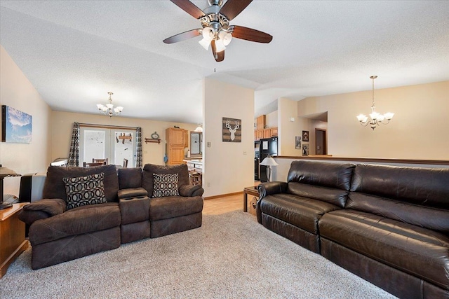 carpeted living room featuring a textured ceiling, vaulted ceiling, and ceiling fan with notable chandelier