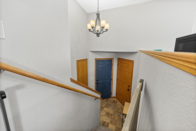 staircase featuring an inviting chandelier