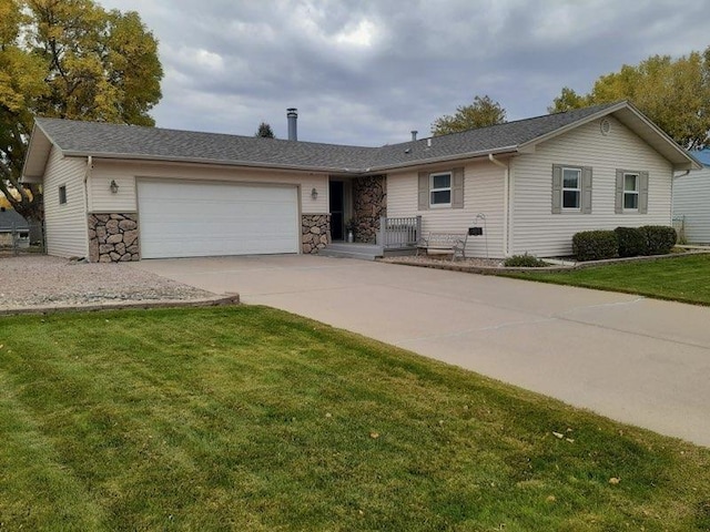 ranch-style house with a garage and a front lawn