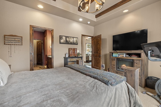 bedroom with an inviting chandelier, carpet floors, and ensuite bathroom