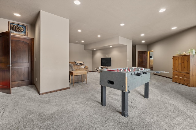 rec room featuring light carpet