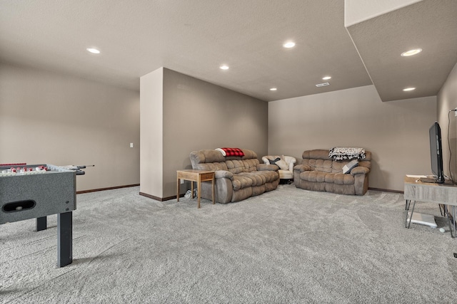 playroom featuring light carpet and a textured ceiling