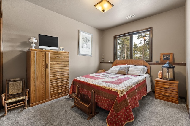 bedroom featuring dark carpet