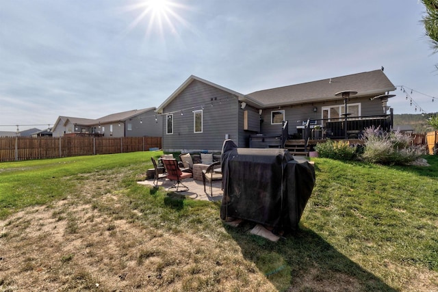 back of property with a wooden deck, a patio area, and a lawn