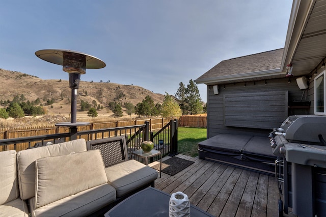 deck featuring a mountain view and area for grilling