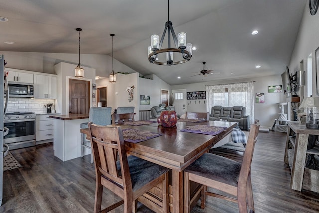 dining area featuring vaulted ceiling, dark hardwood / wood-style flooring, and ceiling fan with notable chandelier