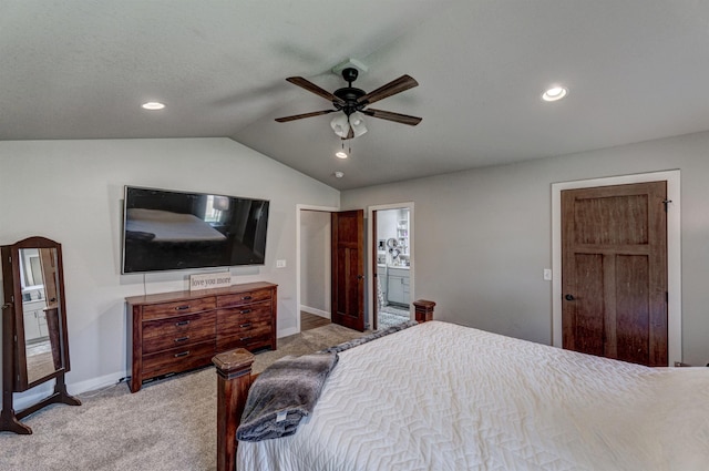 carpeted bedroom featuring ceiling fan, connected bathroom, and lofted ceiling