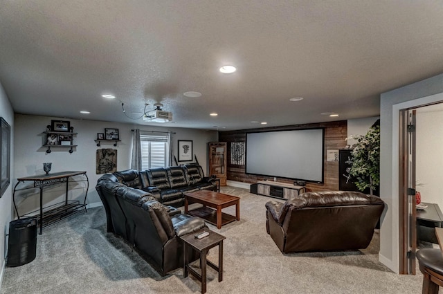 cinema with light colored carpet and a textured ceiling