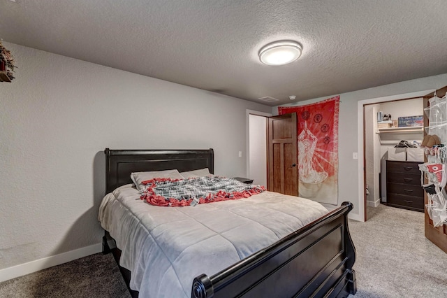 bedroom with carpet and a textured ceiling