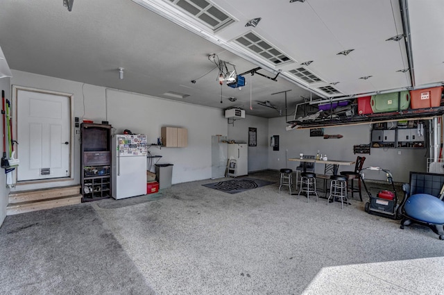 garage featuring a garage door opener, white fridge, and white fridge with ice dispenser