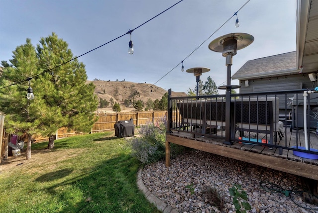 view of yard featuring a deck with mountain view