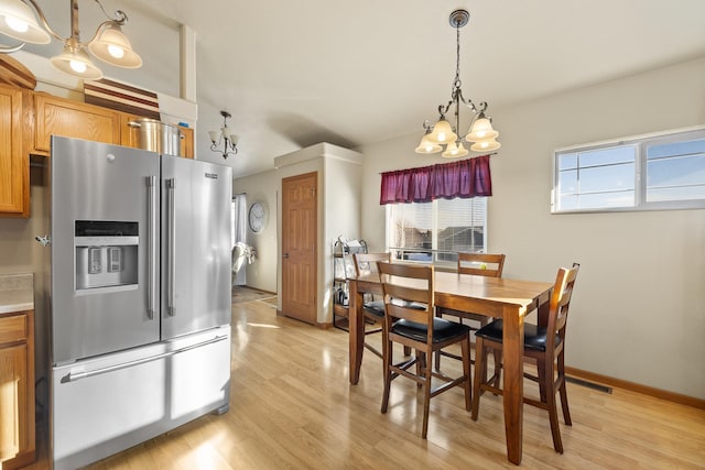 dining room featuring a chandelier and light hardwood / wood-style flooring