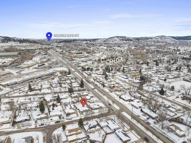 snowy aerial view featuring a mountain view