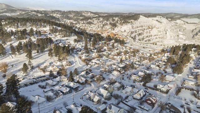 snowy aerial view featuring a mountain view