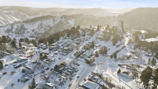 snowy aerial view with a mountain view