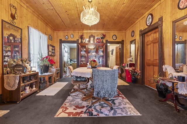 carpeted dining area with wooden walls, wooden ceiling, and an inviting chandelier