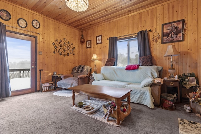 carpeted living room with an inviting chandelier, wood ceiling, and wood walls