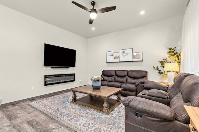 living room with ceiling fan and hardwood / wood-style flooring