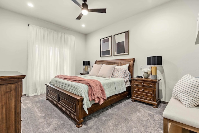 bedroom with ceiling fan and dark colored carpet