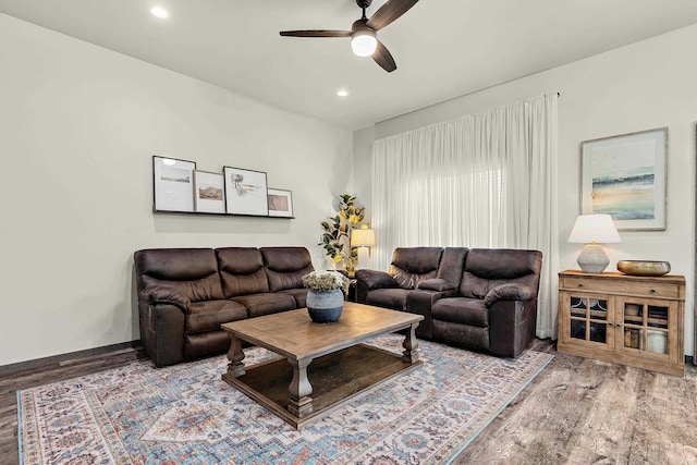 living room with ceiling fan and hardwood / wood-style floors