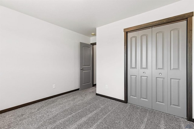 unfurnished bedroom featuring a closet and carpet flooring