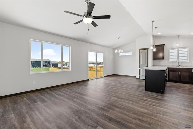 unfurnished living room featuring dark wood-type flooring, sink, and vaulted ceiling