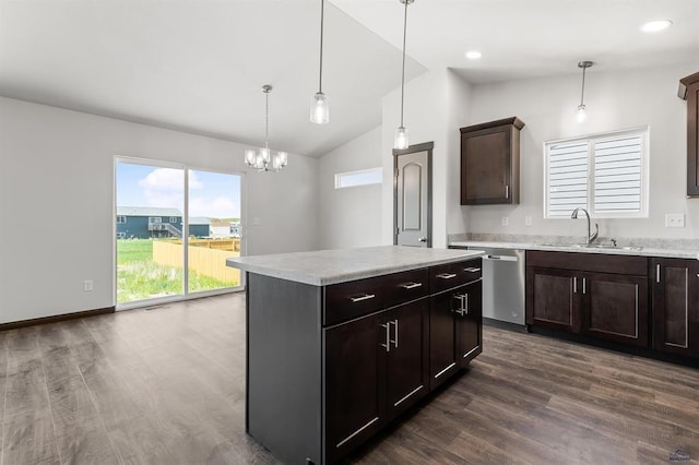 kitchen featuring vaulted ceiling, dishwasher, pendant lighting, a kitchen island, and sink