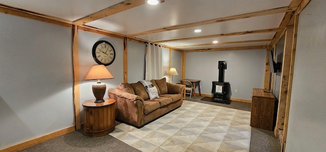 carpeted living room with a wood stove and beamed ceiling