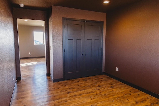 unfurnished bedroom featuring hardwood / wood-style flooring