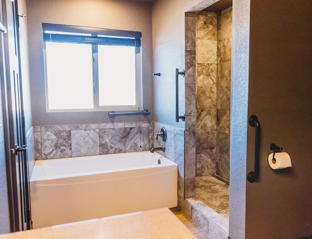 bathroom with shower with separate bathtub