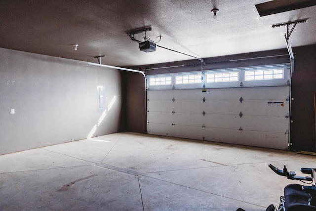 garage with electric panel and a garage door opener