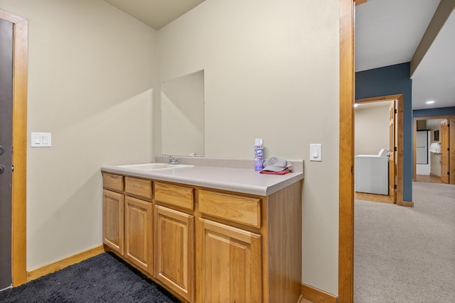 bathroom with vanity and washer / dryer