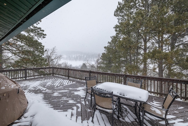 snow covered deck with grilling area