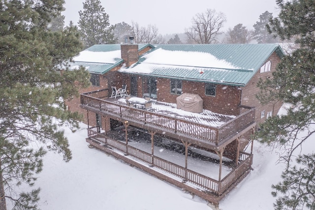 snow covered property featuring a wooden deck