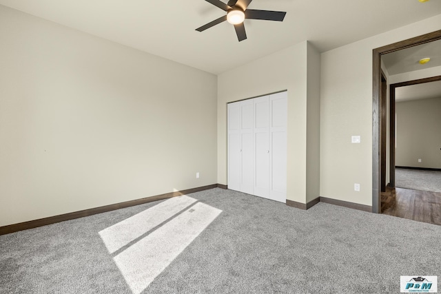 unfurnished bedroom with dark colored carpet, a closet, and ceiling fan