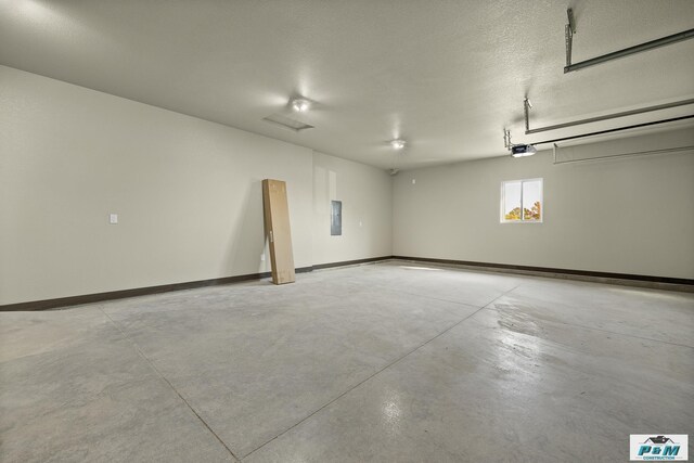 garage with electric panel and a garage door opener