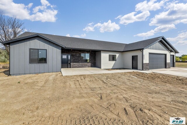 ranch-style home with a garage and a patio