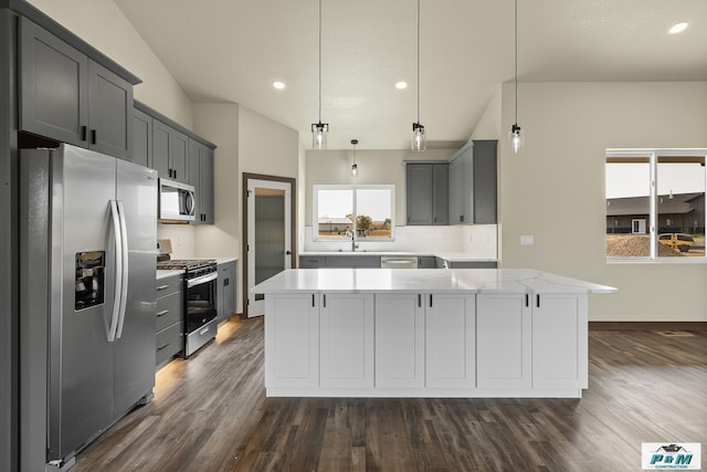 kitchen with hanging light fixtures, gray cabinetry, and stainless steel appliances