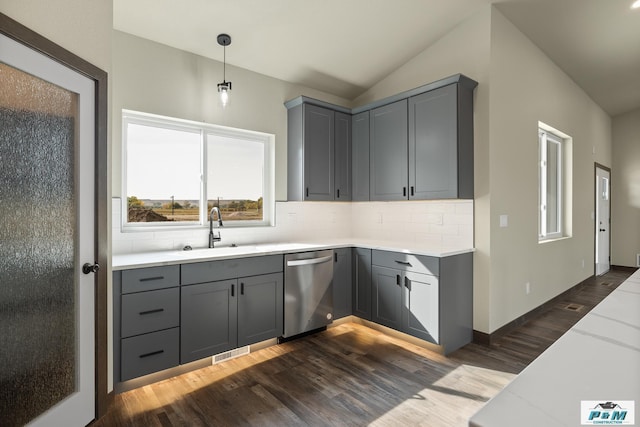 kitchen featuring sink, hanging light fixtures, gray cabinets, light stone counters, and stainless steel dishwasher