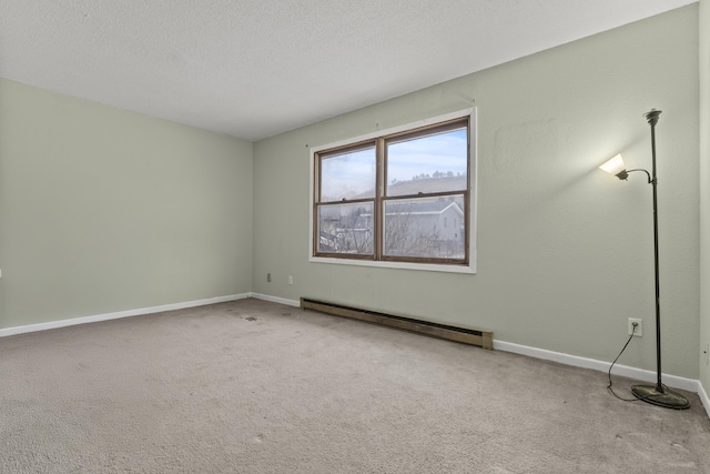 carpeted spare room featuring a baseboard radiator and a textured ceiling