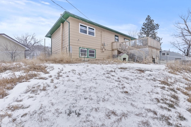 view of snow covered back of property