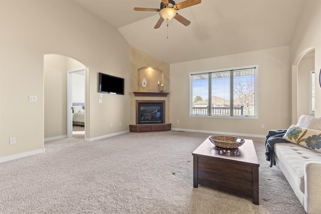 living room featuring ceiling fan, light colored carpet, and lofted ceiling