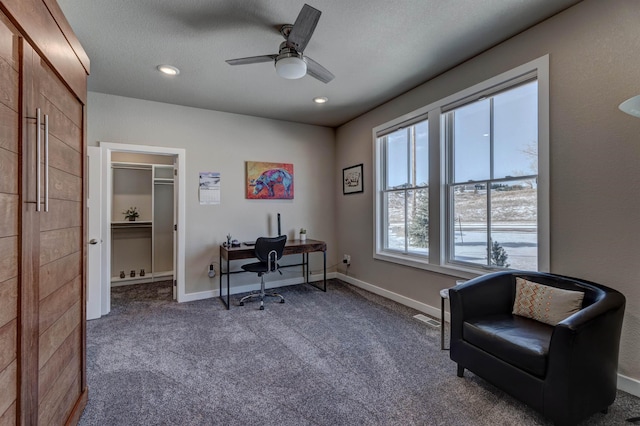 carpeted office with ceiling fan and a textured ceiling