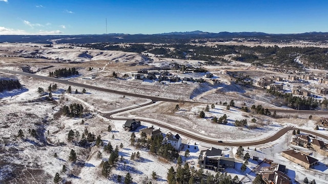 snowy aerial view featuring a mountain view