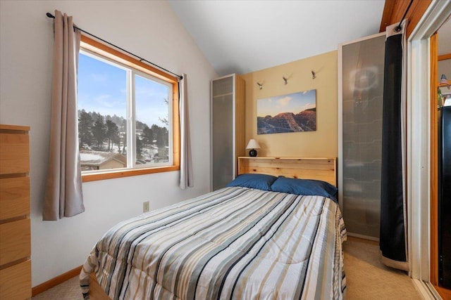 bedroom featuring lofted ceiling and light carpet