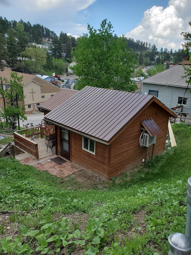 rear view of property featuring a wooden deck