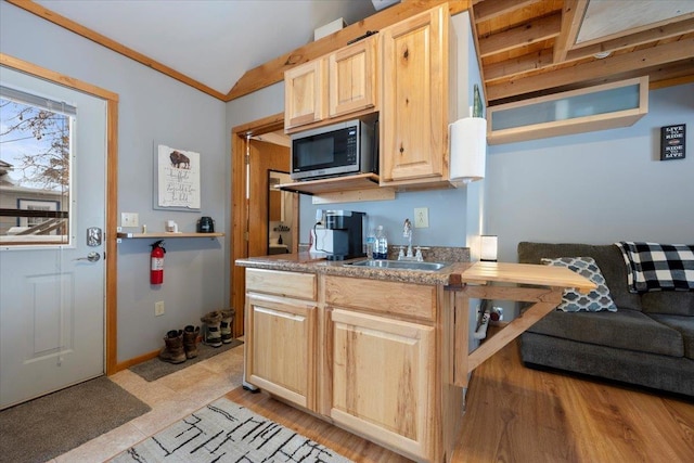 kitchen featuring ornamental molding, sink, and light brown cabinets