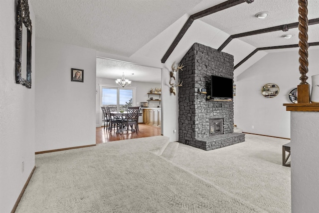 living room with carpet, a notable chandelier, a textured ceiling, a brick fireplace, and vaulted ceiling