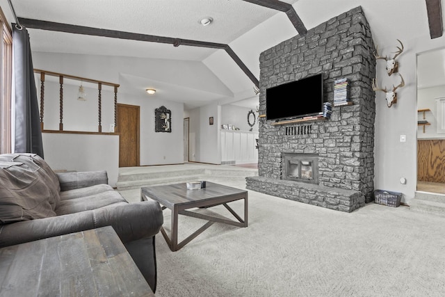 carpeted living room with a stone fireplace, vaulted ceiling with beams, and a textured ceiling