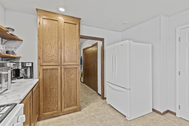 kitchen featuring white refrigerator and range